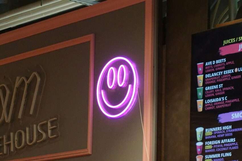 a neon sign that is on the side of a building