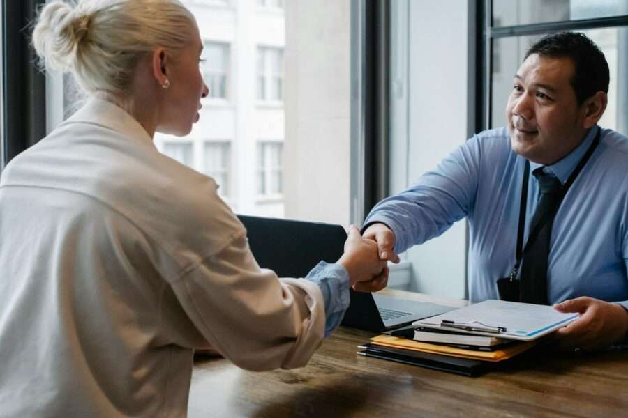 Photo by Sora Shimazaki Two professionals in an office setting shaking hands after a business agreement.